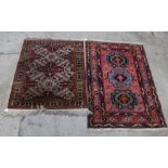 Two small geometric patterned rugs with red and cream grounds respectively,