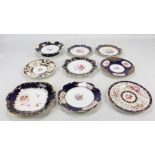 Nine Coalport floral decorated gilt heightened plates and dishes, each with blue borders,