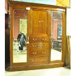 An Edwardian mahogany and inlaid wardrobe with moulded cornice above central cupboard door above