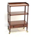 A Victorian rosewood three tier whatnot of rectangular form with barleytwist uprights,