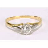 An unmarked yellow and white metal diamond solitaire ring, the round brilliant cut stone approx 0.