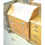 An oak bureau with inlaid top and fall-front above three drawers, width 76.5cm.