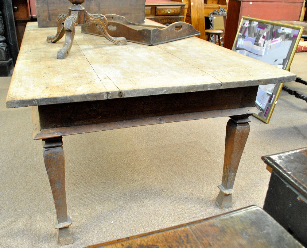 A large oak triple plank top table raised on square sectioned tapering legs, 207 x 114cm.