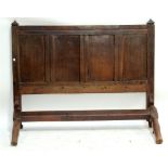 An oak bed, the headboard constructed from the panel from an 18th century coffer,