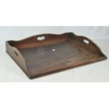 A 19th century mahogany butler's tray with three quarter pierced gallery (lacking stand),