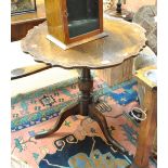 A 19th century oak tilt-top occasional table with piecrust shaped top,