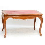 A circa 1900 French walnut centre table of serpentine outline,