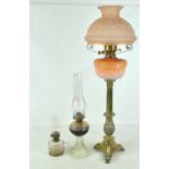 A Victorian brass oil lamp with opaque graduated pink glass reservoir and frosted peach shade (af),