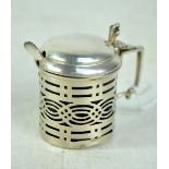 NATHAN & HAYES; an Edward VII hallmarked silver pierced mustard pot with blue glass liner,