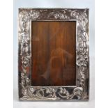 An early 20th century silver plated photo frame embossed with stylised lily of the valley motifs