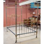 A good Victorian brass and steel tubular four poster bed with pierced head and foot boards,