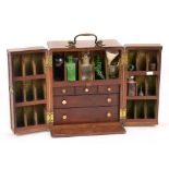 An early 19th century mahogany travelling medicine chest or apothecary cabinet with brass top