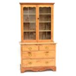 A pine bookcase on cupboard,