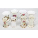 Eight Coalport spill vases, some with landscape painted decoration,