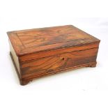A 19th century rosewood rounded rectangular simple lidded box with quarter veneered top,