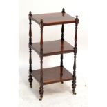 A Victorian rosewood three tiered whatnot of rectangular form raised on brass castors, height 82cm,
