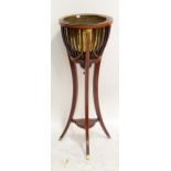 An Edwardian mahogany and inlaid jardinière stand with brass liner,
