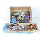 A collection of mixed costume jewellery including bangles, beads, necklaces, loose stones,