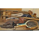 A croquet set (box af), a small group of tennis rackets,