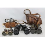 A leather cased pair of early 20th century field glasses,