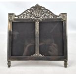 An early 20th century electroplated double photo frame with acanthus leaf and rose motifs decorated