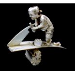 A Japanese Meiji period carved ivory okimono modelled as a man sawing plank of wood with two