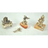 Four Israeli silver filled figures comprising a boy reading Torah, on marble base,