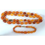 A hand knotted butterscotch/egg yolk amber bead necklace and matching bracelet,