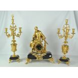 A decorative late 19th century French black slate and gilt metal three piece clock garniture,