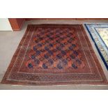 A red ground carpet with geometric decoration, approx 369 x 312cm.