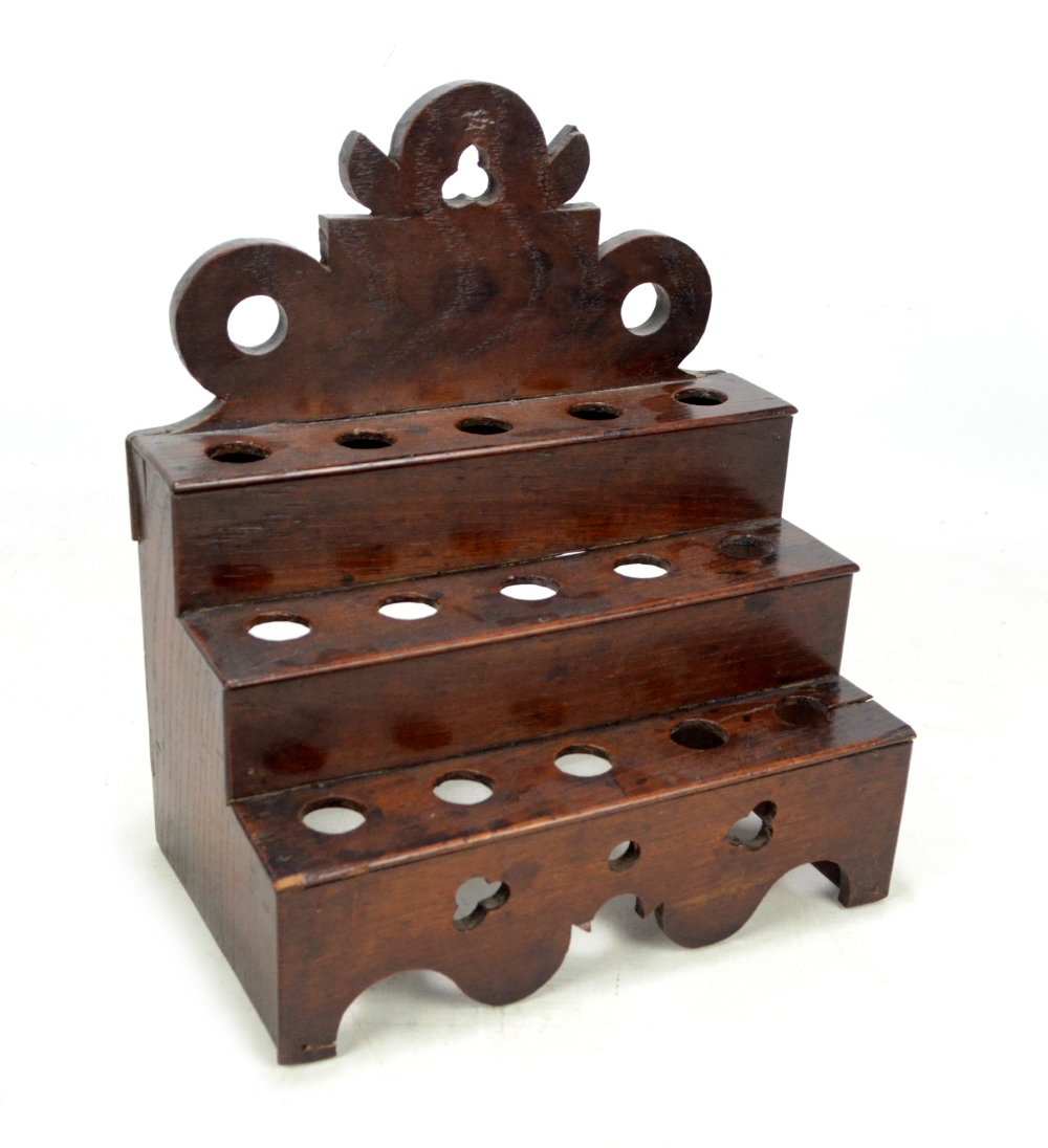 A George III oak spoon rack with shaped pierced back above three steps,