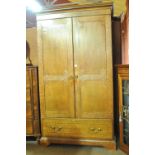 An Edwardian oak and chevron or chequered inlaid two door wardrobe with drawer to the base and