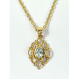 A 9ct yellow gold openwork pendant set with light blue oval cut stone and a 9ct yellow gold chain,