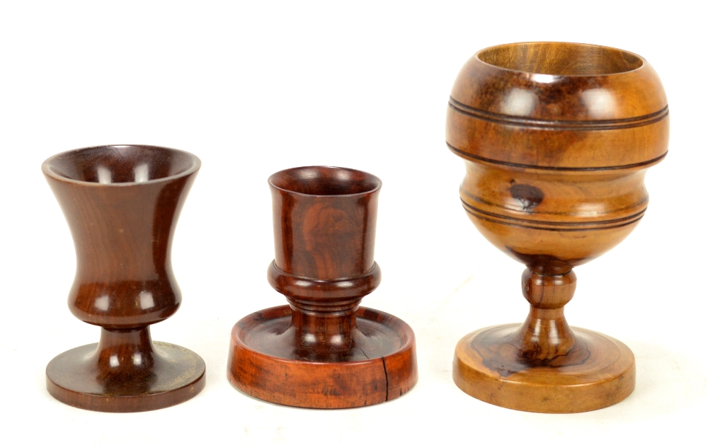 A 19th century turned rosewood candle holder with slightly dishes base, inscribed 'IJM',