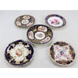 Five Coalport floral decorated gilt heightened cabinet plates with dark blue borders,