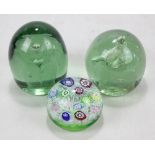 A domed glass millefiori paperweight with date to central canes '1971' and two Victorian green