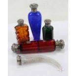 Five late 19th/early 20th century white metal mounted variously coloured glass scent bottles to