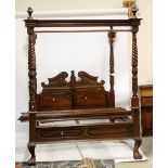 A four poster bed, the headboard with broken swan neck pediment and applied acanthus fretwork,