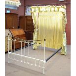 A Victorian white painted cast iron and brass half tester bed with pleated canopy and curtain and