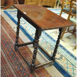 An 18th century oak plank top occasional table with bobbin turned and block supports, height 71cm,