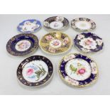 Eight Coalport floral painted gilt heightened cabinet plates with blue ground, diameter 23.5cm (8).