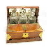 An Edwardian oak and silver plate mounted combination tantalus and games box,