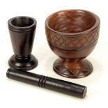 A turned lignum vitae vase, height 14cm, a turned pestle,