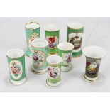 Seven Coalport floral painted green ground gilt heightened spill vases and a similar Bloor Derby