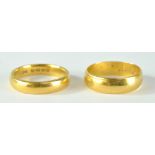 Two 22ct yellow gold bands, sizes N and P, combined approx 11.3g (2).