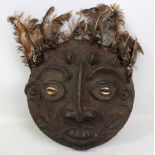 An African tribal mask, Dan, with rattan woven backing, shell eyes and feather adornment,