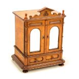 A good mid-19th century figured walnut miniature chest in the form of an armoire,