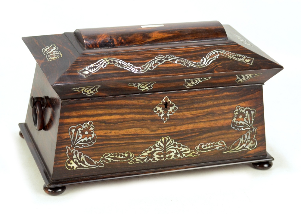 An early Victorian coromandel and mother of pearl inlaid tea caddy of sarcophagus form,