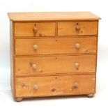 A Victorian pine chest of two short and three long drawers raised on bun feet, width 99cm.