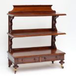 A good early Victorian mahogany three tiered dumb waiter with raised gallery, pierced acanthus